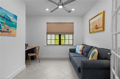Living area with light tile patterned flooring, baseboards, ceiling fan, and recessed lighting