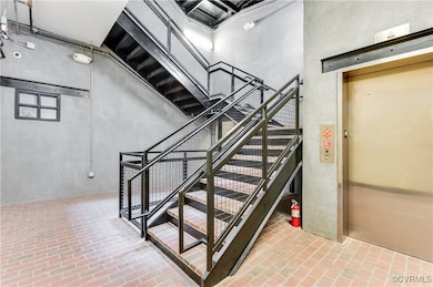 Staircase with brick floors and elevator