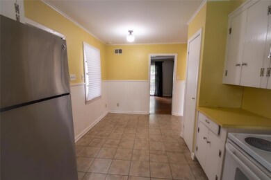 Kitchen with stainless steel fridge, white cabinet