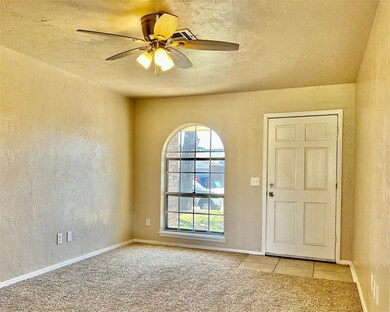 Spare room with ceiling fan and light colored carp