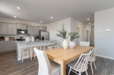 Dining space with recessed lighting, baseboards, and dark wood-style floors