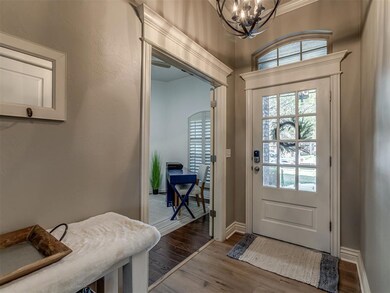 Doorway with a chandelier, hardwood / wood-style f