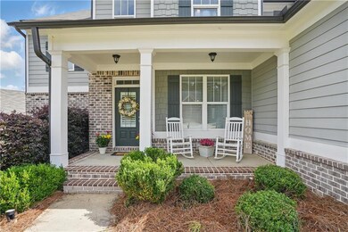 Property entrance with covered porch and brick sid
