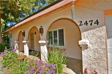 Inviting covered porch entryway with wide arches