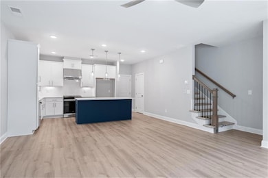 Kitchen with a kitchen island, decorative light fi