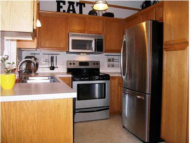 The oak kitchen has terrific stainless appliances 