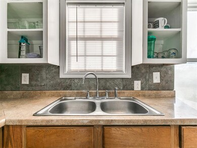 Kitchen featuring decorative backsplash, glass ins