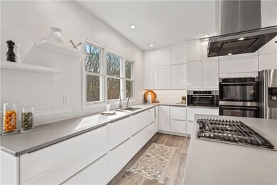 The elegant glass subway tile backsplash perfectly