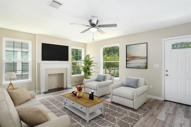 Living room featuring ceiling fan and hardwood / w