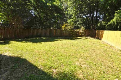 This home features a large fenced backyard with pl