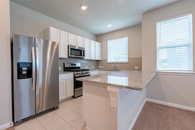 Kitchen featuring appliances with stainless steel