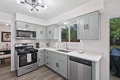 Kitchen with gray cabinets, stainless steel appli