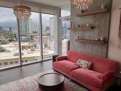 Living area with a chandelier, a city view, and a