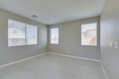 Spare room with light wood finished floors and bas