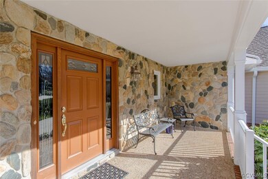 Aggregate front porch with brick steps and archite