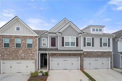Townhome / multi-family property featuring an atta