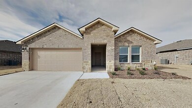 View of front of property featuring a garage and c