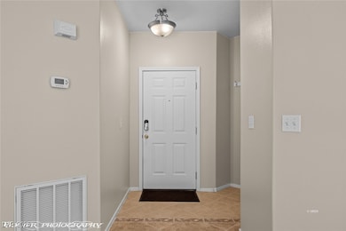 Doorway to outside with light tile patterned floor