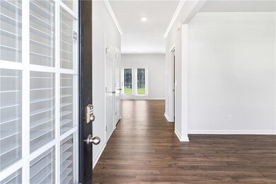 Foyer featuring ornamental molding, dark wood-style flooring, and recessed lighting