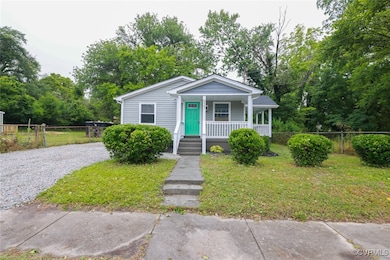 Bungalow featuring covered porch and driveway