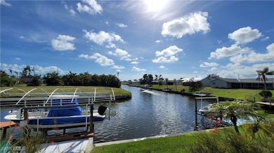 Dock area featuring a water view, a yard, and boat