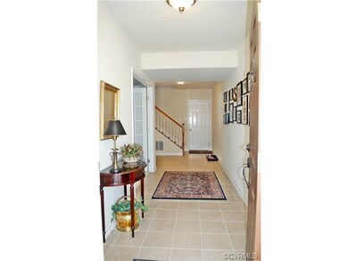 Foyer with tile floor and lighting.