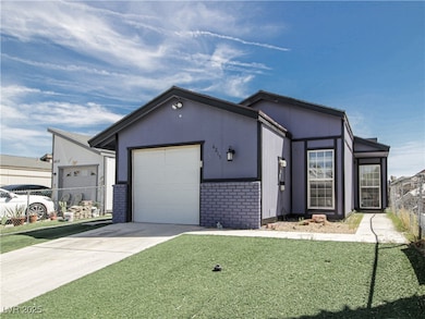View of front of property featuring fence, brick siding, a garage, a front yard, and concrete driveway