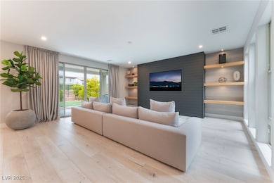 Living room with light wood finished floors and re