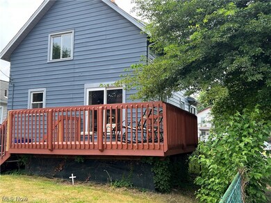 Rear view of property featuring a wooden deck