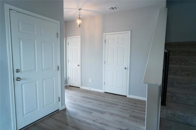 Entrance foyer with wood finished floors and base