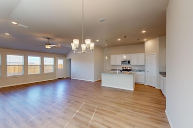 Kitchen featuring white cabinetry, light LVP floor