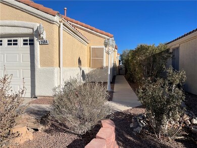 View of side of property with a tiled roof, an att