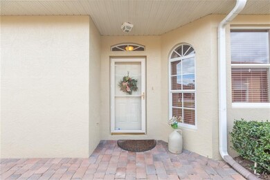 Front door to the villa with nice storm door and p