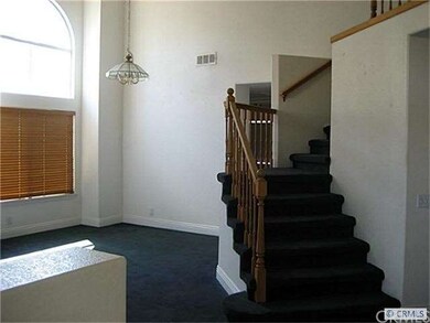 View of living room and staircase from front door
