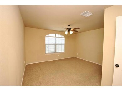 Empty room with ceiling fan, carpet, and baseboar