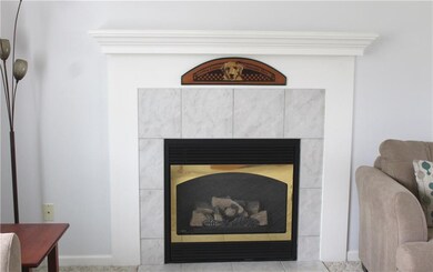 Close up view of gas fireplace with wood mantel ..