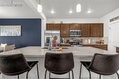 Kitchen featuring tasteful backsplash, stainless steel appliances, hanging light fixtures, light countertops, and recessed lighting