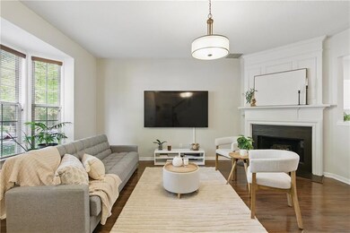 Living room featuring a fireplace, dark wood-type 