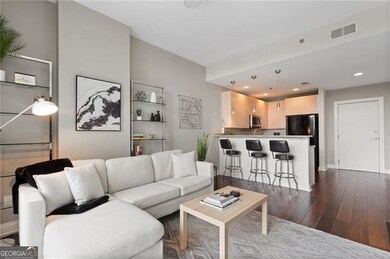 Living room featuring dark wood-style flooring and recessed lighting