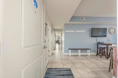 Hallway featuring light tile patterned floors