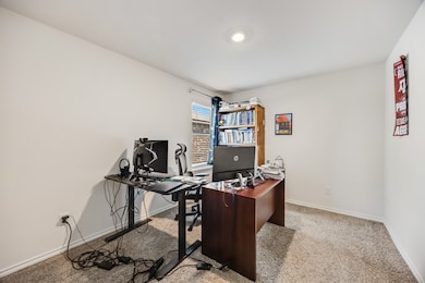 Office area with light colored carpet and baseboards