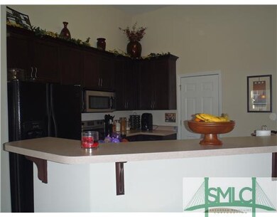 Kitchen. The open bar provides lots of room for ad