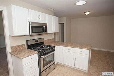 View of kitchen towards dining area. Has nice skyl