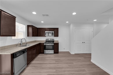 Kitchen with stainless steel appliances, dark brow