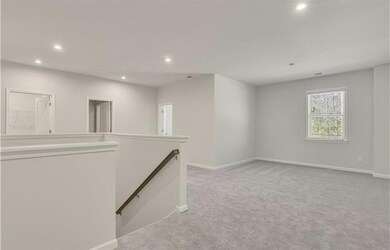 Empty room with light carpet, baseboards, and recessed lighting