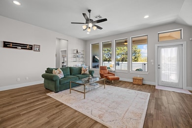 Living area with visible vents, baseboards, wood 