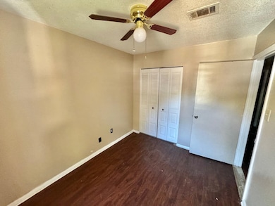Unfurnished bedroom featuring a closet, a textured