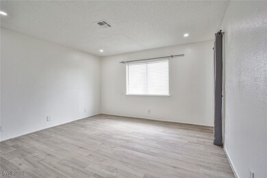 Unfurnished room with a textured ceiling, wood fin