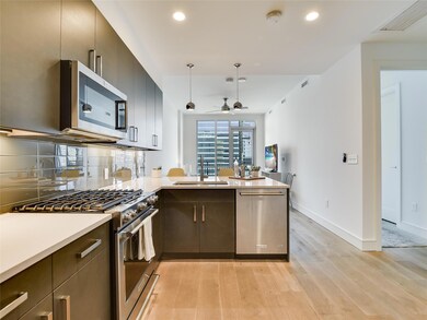 Kitchen with visible vents, a peninsula, applianc