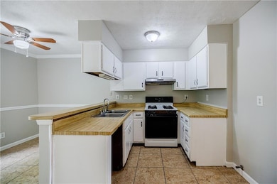 Kitchen with a ceiling fan, under cabinet range ho
